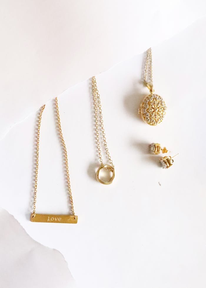 Beautiful assortment of gold jewelry including necklaces, earrings, and pendants.
